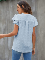 Light blue textured voile blouse with flutter sleeves and a v-neckline.