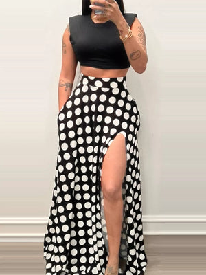 Chic black and white polka dot maxi skirt with a high slit and pockets.