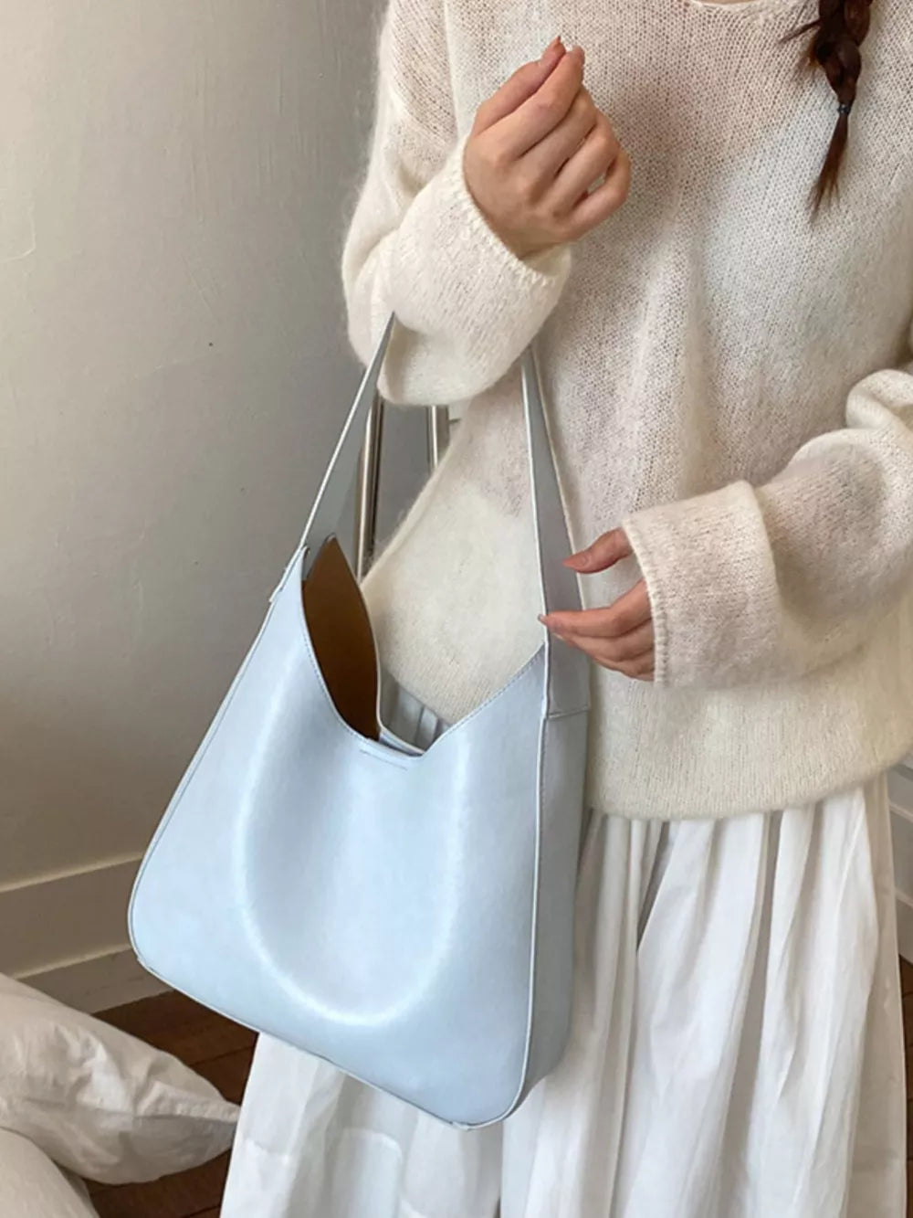 Sleek large blue pu leather shoulder bag with a slouchy silhouette.