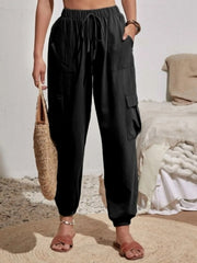 Black textured cargo lounge trousers with drawstring waist and multiple pockets.