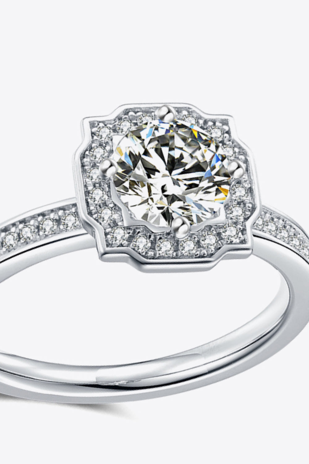 Silver halo diamond engagement ring with pavé band.