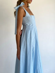 Light blue maxi dress with bow tie shoulder straps and square neckline.