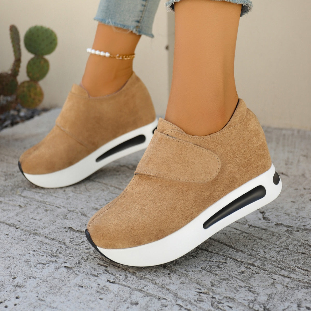Chunky platform sneakers in brown with air cushion sole and hook-and-loop strap.