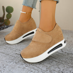 Chunky platform sneakers in brown with air cushion sole and hook-and-loop strap.