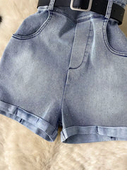 Blue denim romper with rhinestone embellishments, pockets, and a black belt.