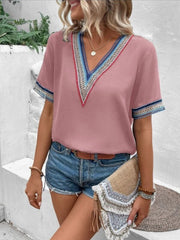 Dusty Pink V-neck top with colorful embroidered trim on neckline and sleeves.