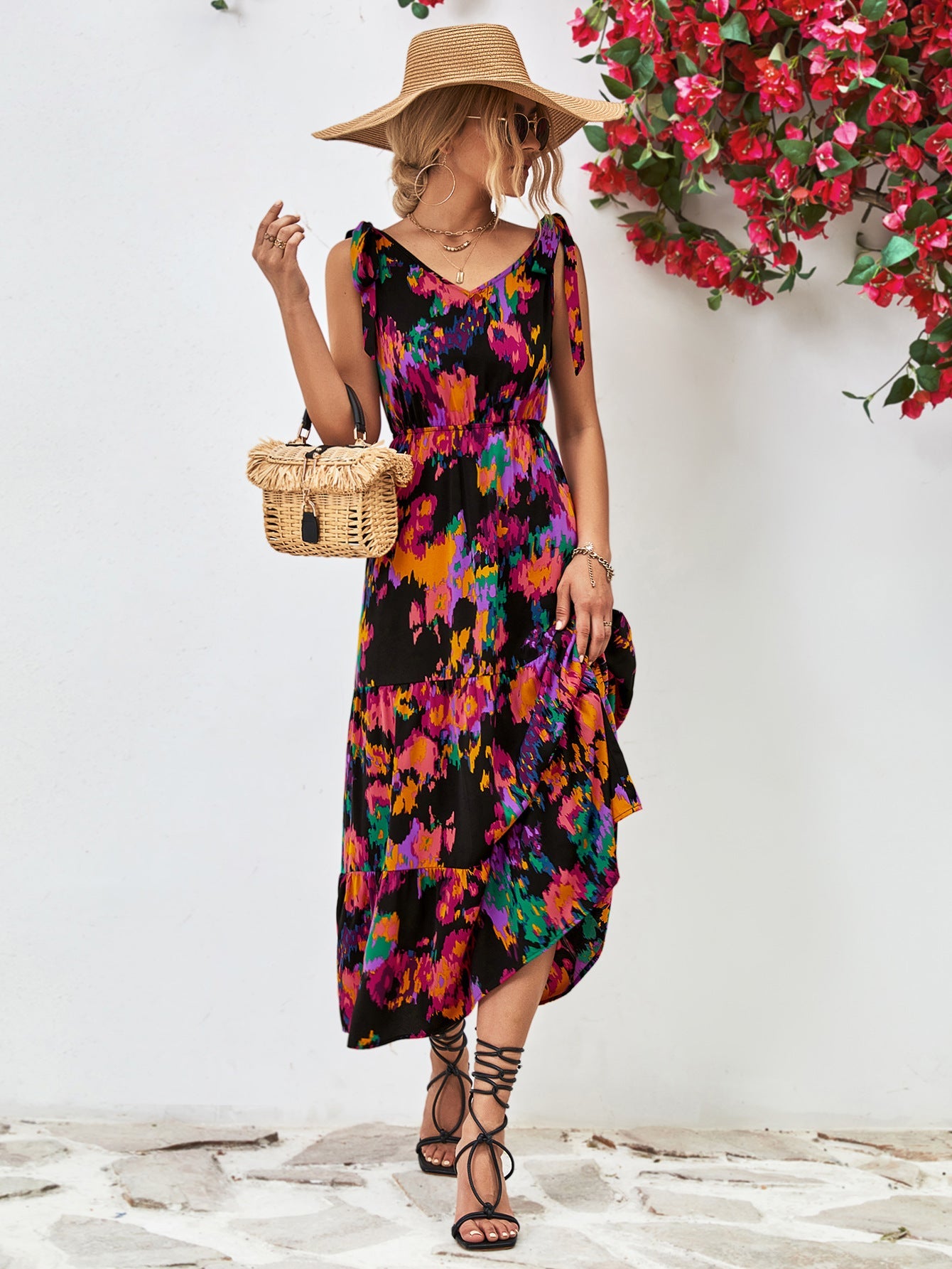 Maxi dress with abstract print, tie straps, and tiered ruffle hem.