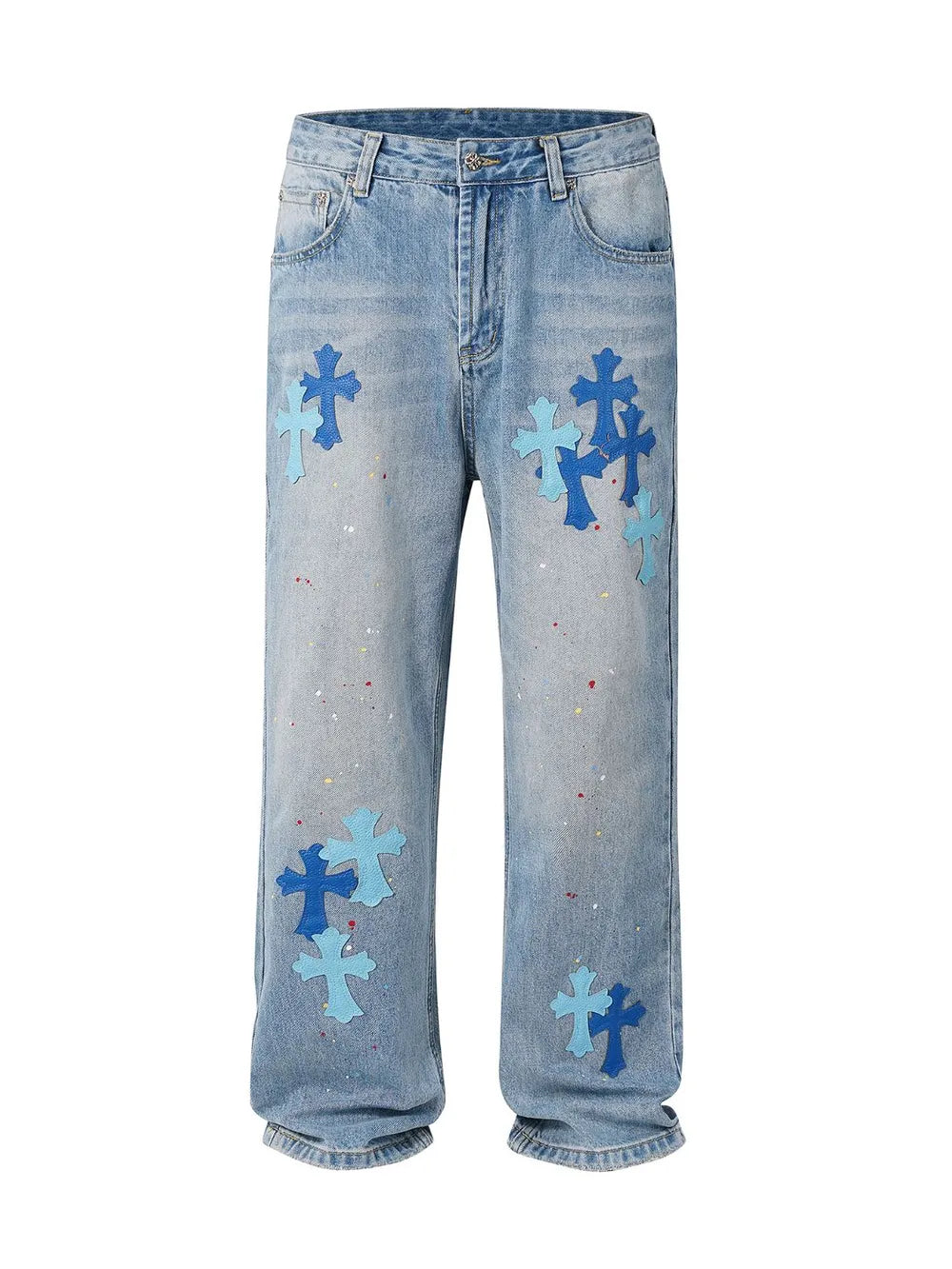 Light wash denim jeans with embroidered cross patches and paint splatters.