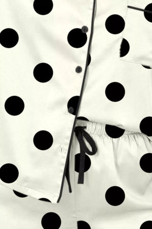 Polka dot pajama set with button-up top and drawstring waist pants.