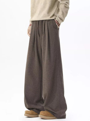 Brown wide-leg sweatpants with adjustable drawstring waist and pockets.