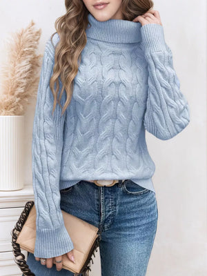 Sky blue cable-knit turtleneck sweater with long sleeves and ribbed cuffs.
