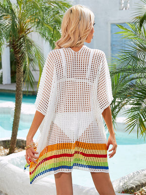 White crochet beach cover-up with rainbow stripe hem and short sleeves.