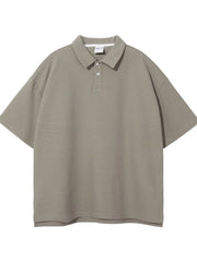 Boxy textured polo shirt in Khaki with short sleeves and a two-button placket.
