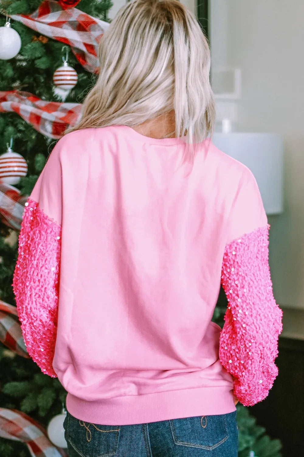 Pink sweatshirt with sequin sleeves and "Love" appliqué detail