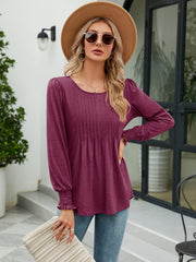Pleated bodice gathered sleeve top in burnt coral with a scoop neck and ruched cuffs.