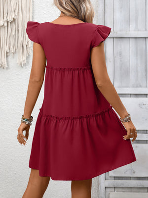 Wine red ruffled cap sleeve mini dress with tiered skirt and textured fabric.
