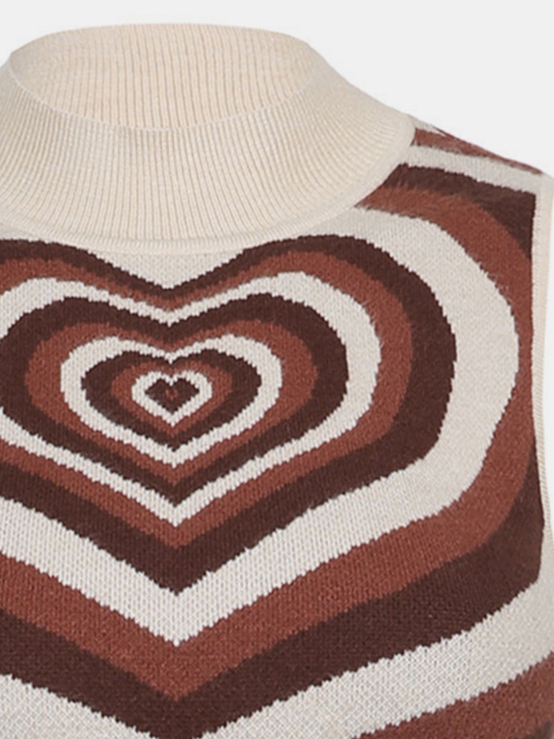 Brown knit tank top with concentric heart intarsia pattern and cream mock neck.