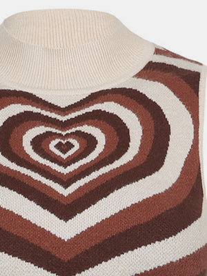 Brown knit tank top with concentric heart intarsia pattern and cream mock neck.