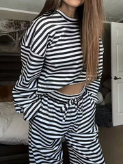 Black and white striped pajama set with drawstring waist pants and long sleeve top.
