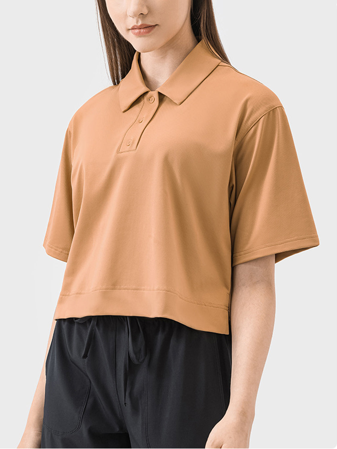 Cropped polo top in beige with short sleeves and a button placket.