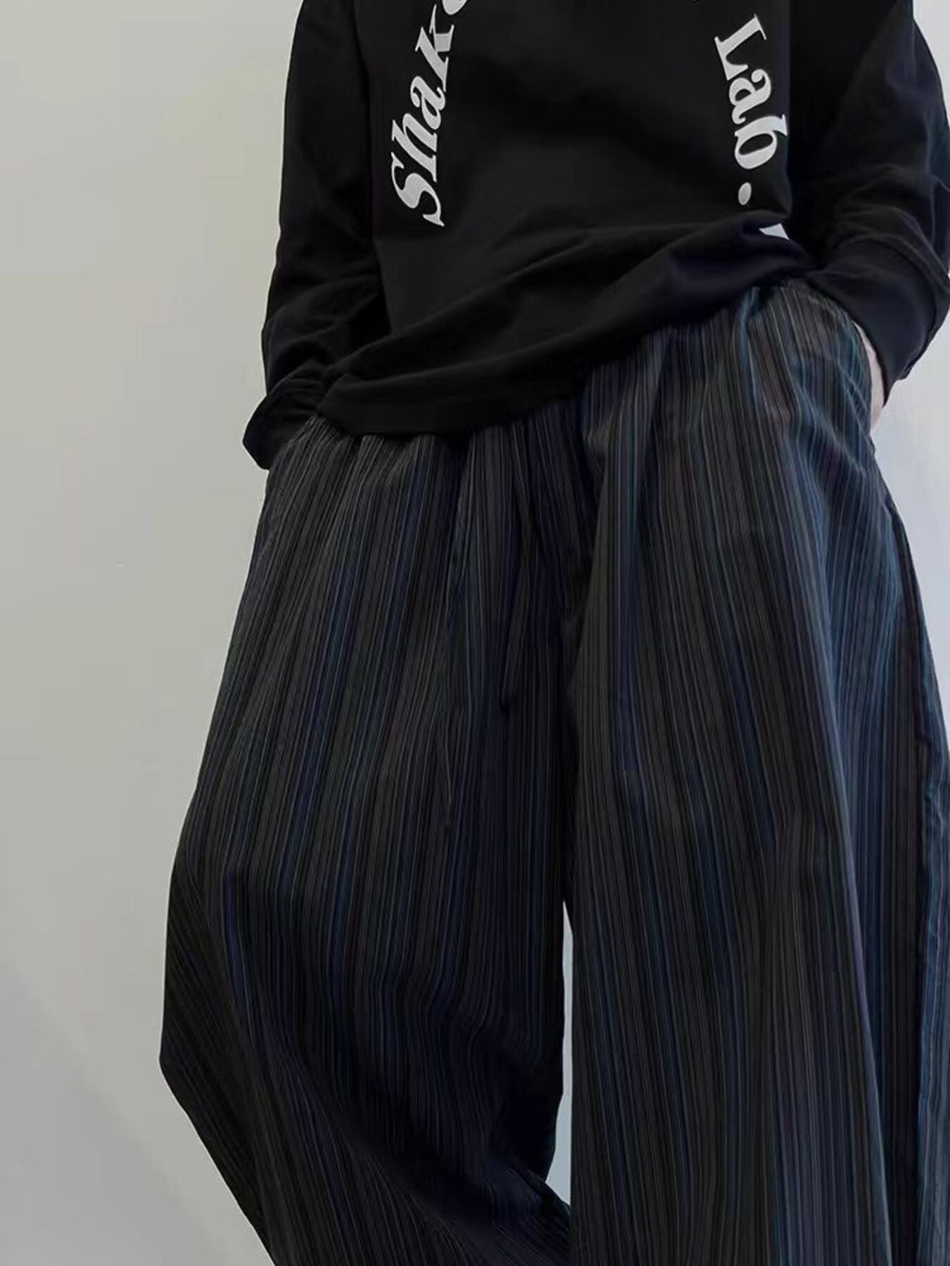 Men's wide leg sweatpants in dark blue with subtle pinstripes and pockets.