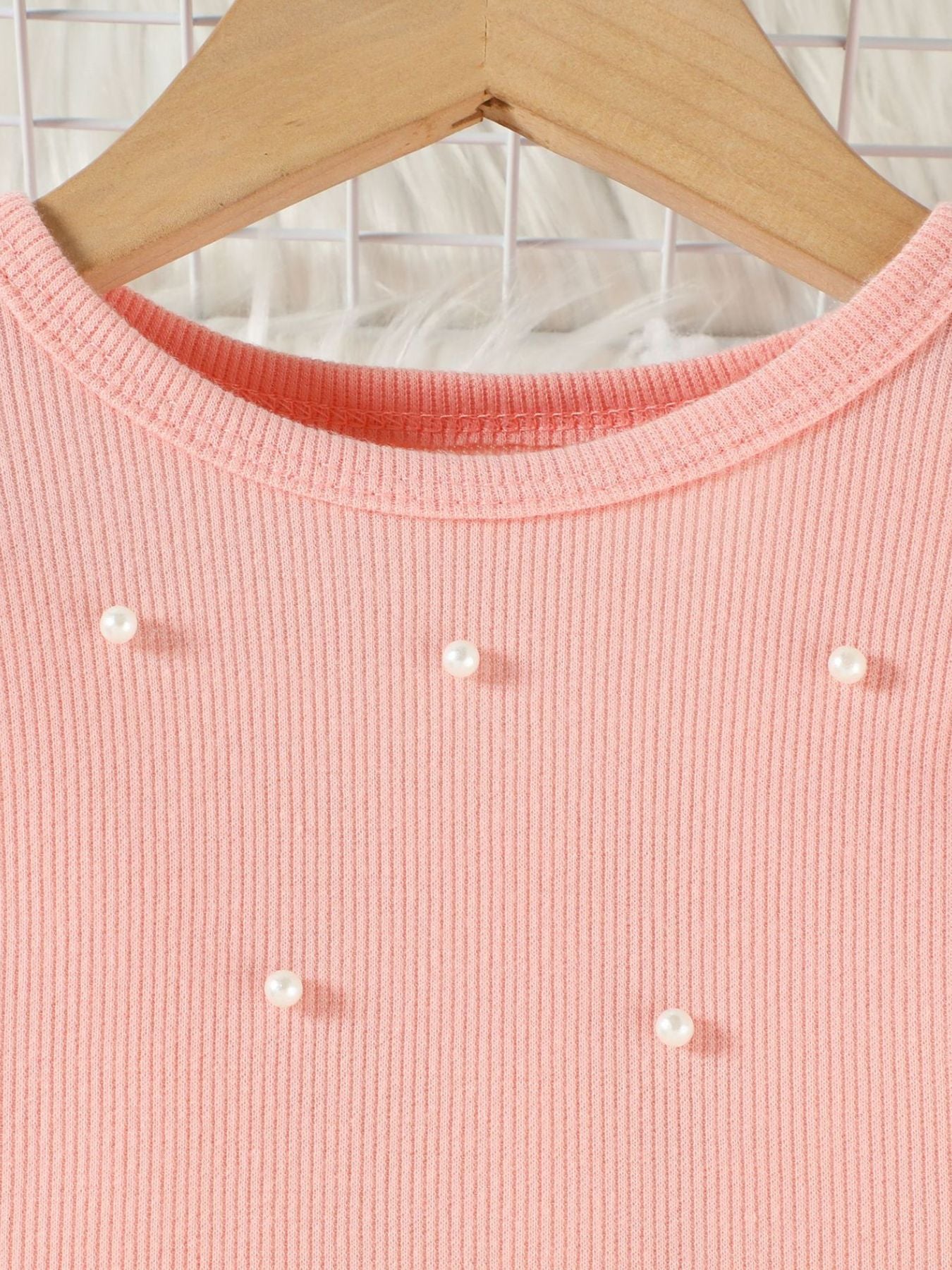 Pink ribbed baby top with pearl embellishments