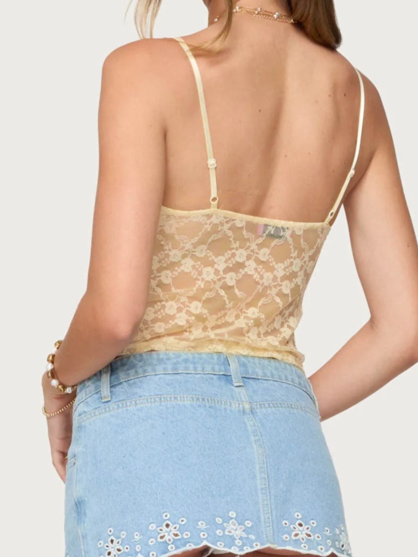 Sheer floral lace cami with adjustable straps in pastel yellow.