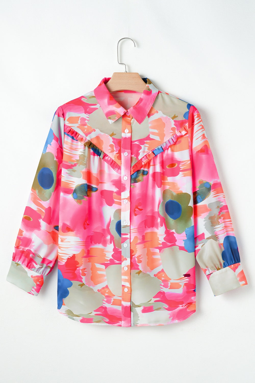 Pink abstract painterly ruffle front blouse with long sleeves.