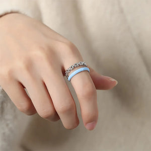Chain link and light blue enamel open ring on a finger