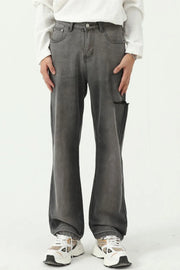 Faded flare denim jeans in dark wash with distressed knee detail and a relaxed fit.