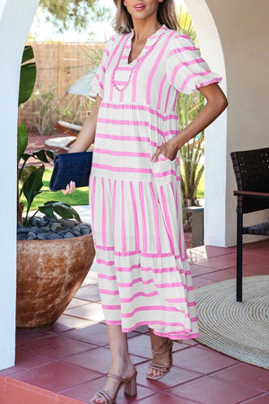 Maxi dress with pink stripes, notched neck, short sleeves, tiered skirt, and pockets.