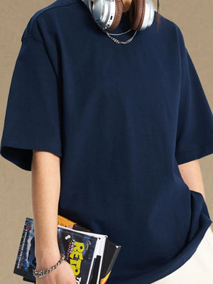 Navy boxy cut t-shirt with short sleeves and a crew neck, styled casually.