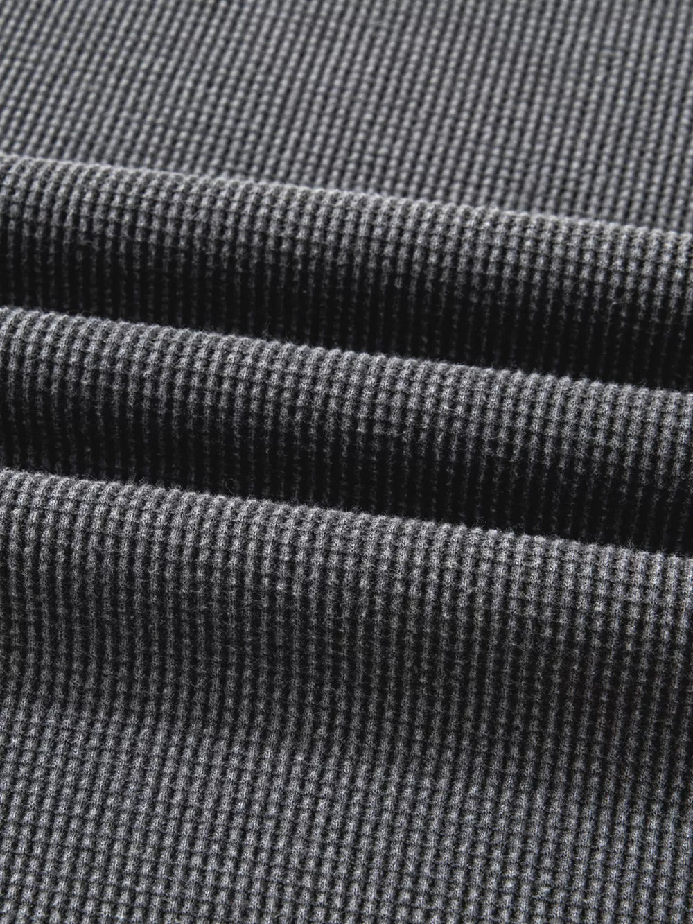 Dark gray waffle knit oversized sweatshirt with textured cotton blend fabric detail.