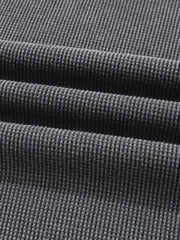 Dark gray waffle knit oversized sweatshirt with textured cotton blend fabric detail.