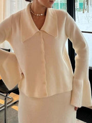 Milky white ribbed knit cardigan with collar and bell sleeves, paired with a matching knit skirt.