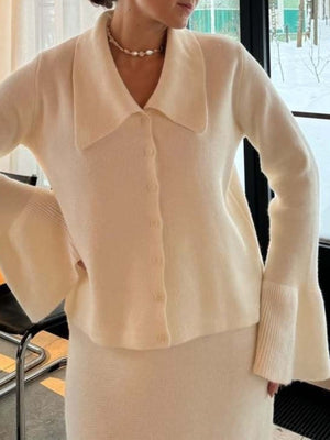 Milky white ribbed knit cardigan with collar and bell sleeves, paired with a matching knit skirt.