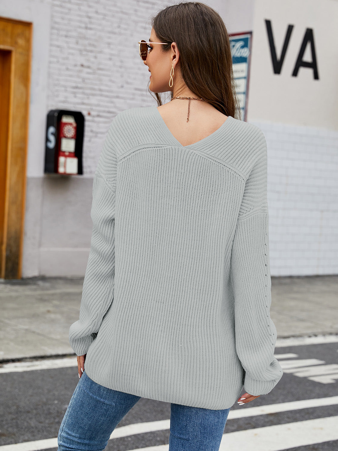 Slouchy ribbed knit sweater in heather gray with subtle sleeve detail and V-neck.