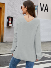 Slouchy ribbed knit sweater in heather gray with subtle sleeve detail and V-neck.