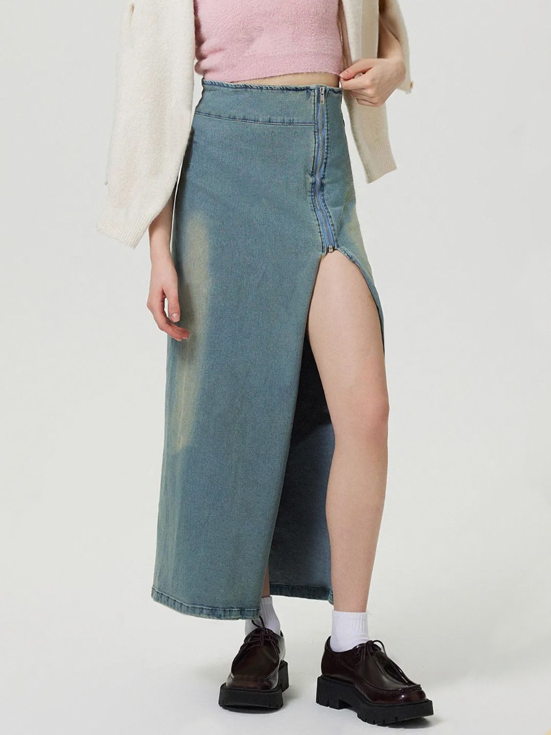 Denim maxi skirt in medium wash with a high slit and front zipper detail.