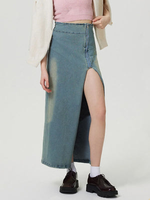 Denim maxi skirt in medium wash with a high slit and front zipper detail.