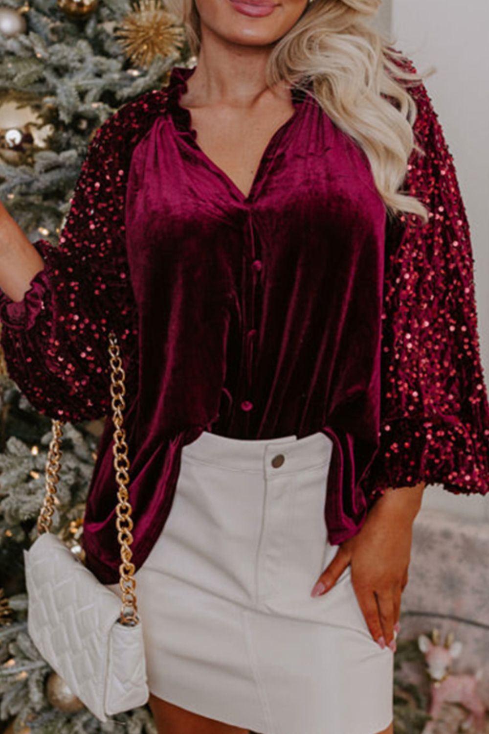 Red velvet blouse with sequin sleeves and ruffled neckline