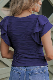 Textured ruffle sleeve bodysuit in dark blue with a wavy pattern.