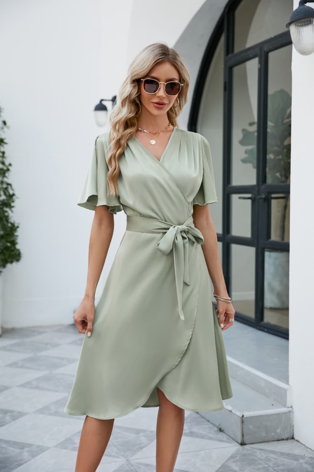 Light green silk wrap midi dress with butterfly sleeves and adjustable tie waist