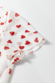 White mesh t-shirt with red heart print and ruffled sleeve hem.