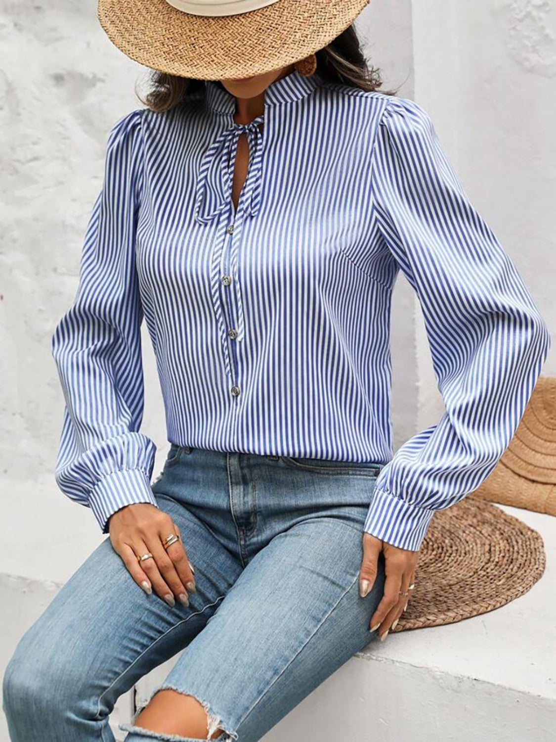 Light blue striped blouse with puffed sleeves and keyhole neckline.