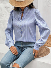 Light blue striped blouse with puffed sleeves and keyhole neckline.