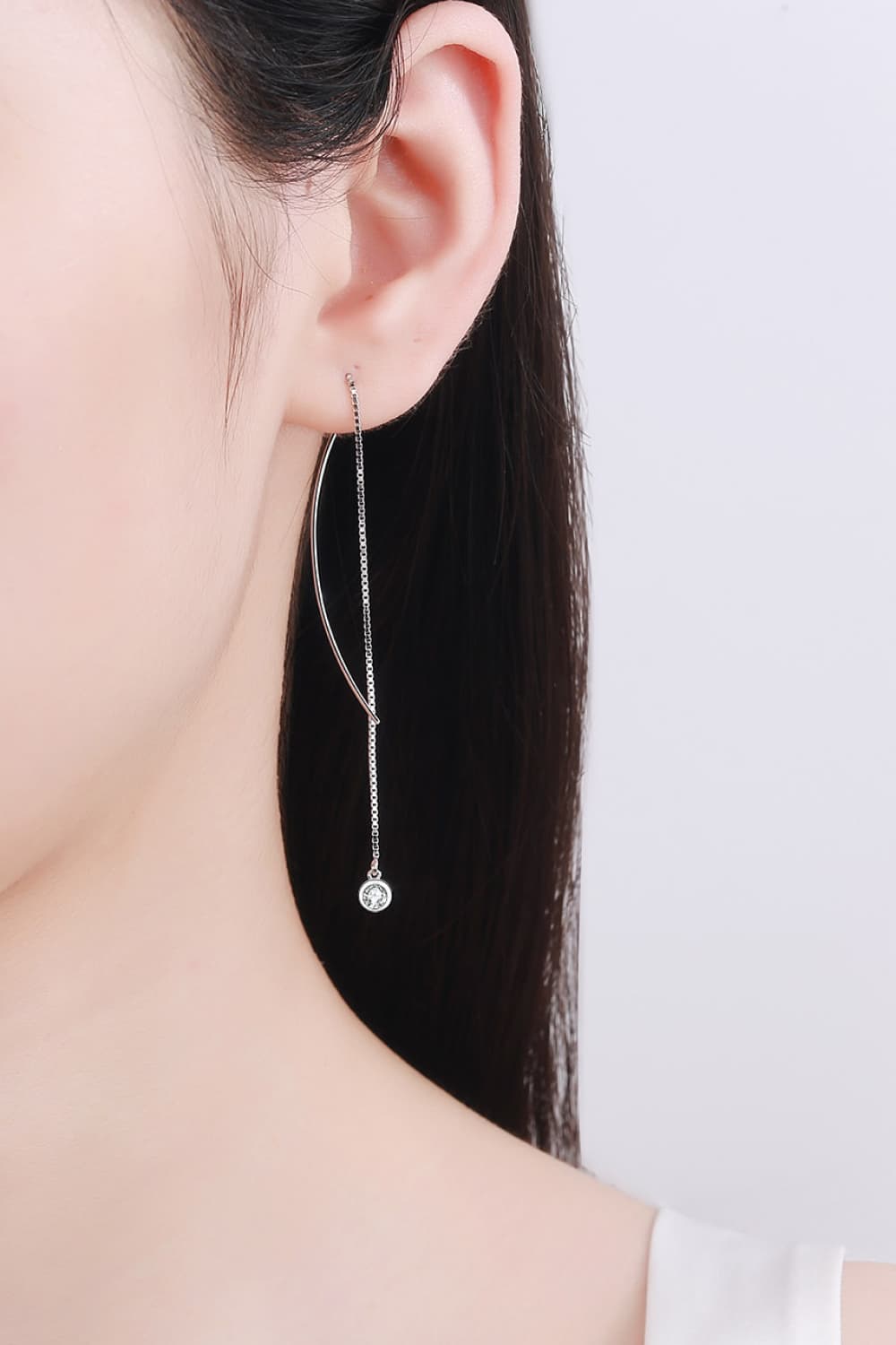 Cascading moissanite threader earrings in silver sterling silver with a single diamond accent.