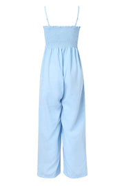 Light blue smocked bodice palazzo jumpsuit with adjustable spaghetti straps and wide legs.