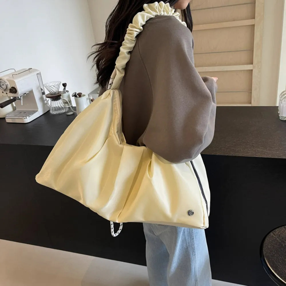 Ivory ruched handle crescent shoulder bag with ruched strap detail.