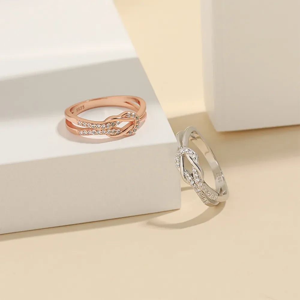 Silver knot ring with zirconia accents and rose gold knot ring with zirconia accents